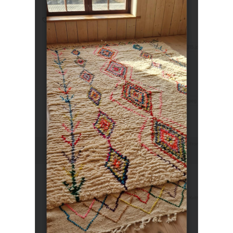 Decorative rug with geometric patterns on a wooden floor.
